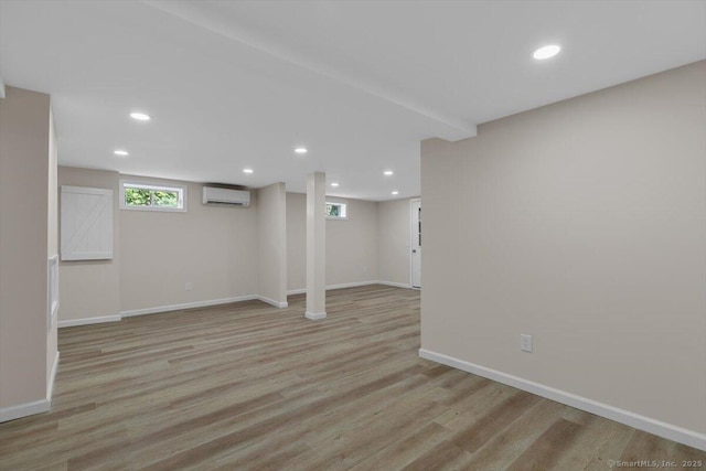 219 Browning Rd, Norwich, CT 06360 - basement with a wall mounted air conditioner, recessed lighting, and light wood-style flooring