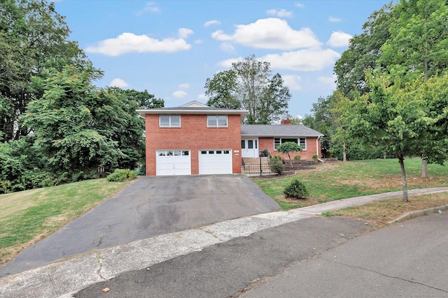 195 Whittier Rd, New Haven, CT 06515 - tri-level home featuring brick siding, a garage, a front lawn, driveway, and a chimney