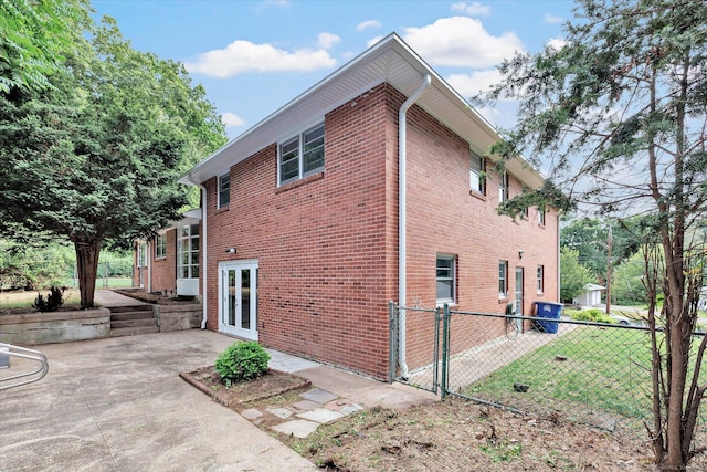195 Whittier Rd, New Haven, CT 06515 - rear view of house with a patio area, brick siding, and french doors