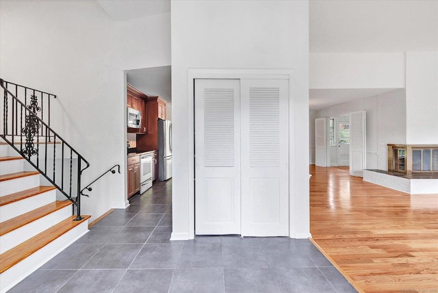 195 Whittier Rd, New Haven, CT 06515 - foyer with dark tile patterned flooring, stairway, and a towering ceiling