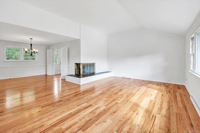 195 Whittier Rd, New Haven, CT 06515 - unfurnished living room with a chandelier, light wood-style flooring, healthy amount of natural light, a multi sided fireplace, and lofted ceiling