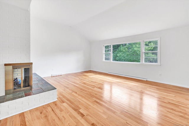 195 Whittier Rd, New Haven, CT 06515 - unfurnished living room featuring baseboard heating, vaulted ceiling, a brick fireplace, and wood finished floors