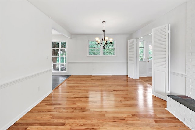195 Whittier Rd, New Haven, CT 06515 - unfurnished dining area featuring healthy amount of natural light, a chandelier, light wood-style floors, and baseboard heating