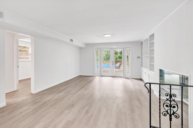 195 Whittier Rd, New Haven, CT 06515 - unfurnished living room with wood finished floors, plenty of natural light, built in features, and french doors