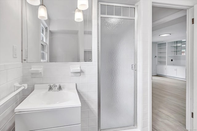195 Whittier Rd, New Haven, CT 06515 - full bathroom with a shower stall, vanity, wood finished floors, tile walls, and built in features