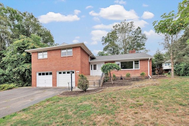 195 Whittier Rd, New Haven, CT 06515 - split level home featuring asphalt driveway, a garage, brick siding, and a front lawn