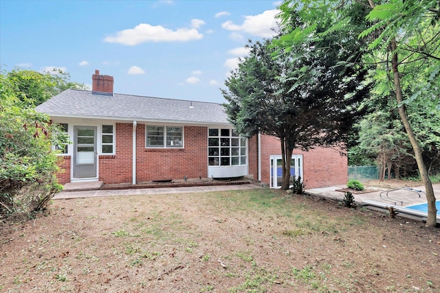 195 Whittier Rd, New Haven, CT 06515 - rear view of property featuring brick siding, a chimney, a shingled roof, and a lawn