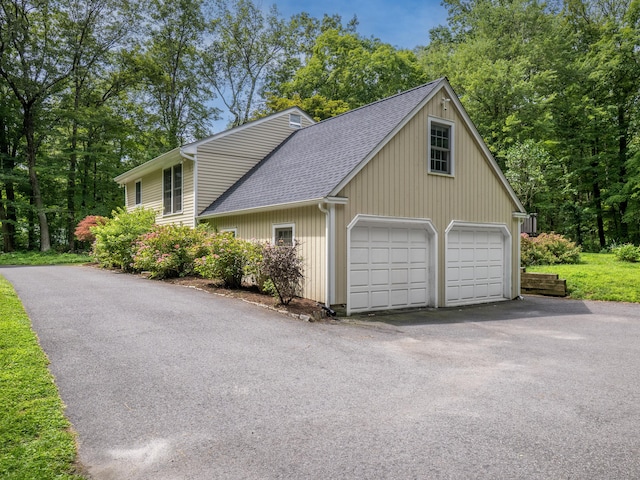 322 Mountain Rd, Wilton, CT 06897 - view of side of property featuring a shingled roof, a garage, and asphalt driveway