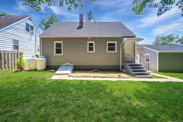 112 Pitt St, Bridgeport, CT 06606 - rear view of property with a chimney, roof with shingles, and an outbuilding