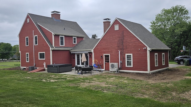 222 Gilead St, Hebron, CT 06248 - back of property with a chimney, a patio area, a hot tub, a yard, and a shingled roof