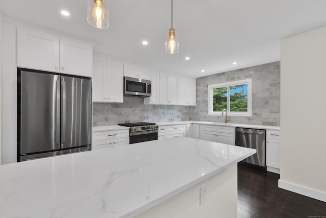 39 Cambridge Dr, Greenwich, CT 06831 - kitchen with appliances with stainless steel finishes, backsplash, light stone countertops, pendant lighting, and recessed lighting