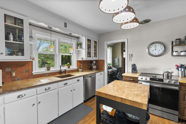 123 George St, Middletown, CT 06457 - kitchen with appliances with stainless steel finishes, open shelves, white cabinetry, wooden counters, and tasteful backsplash