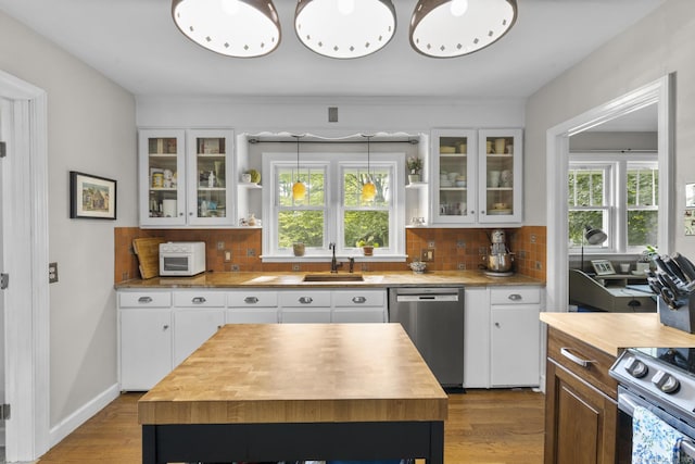 123 George St, Middletown, CT 06457 - kitchen featuring butcher block countertops, stainless steel appliances, wood finished floors, and tasteful backsplash