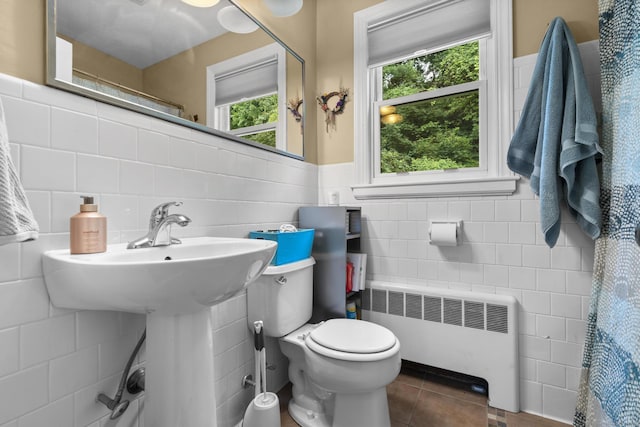 123 George St, Middletown, CT 06457 - bathroom with radiator heating unit, tile walls, tile patterned flooring, and a wainscoted wall