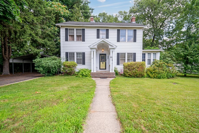 135 Park Ter, Waterbury, CT 06708 - colonial inspired home featuring a carport, a chimney, a front lawn, and driveway