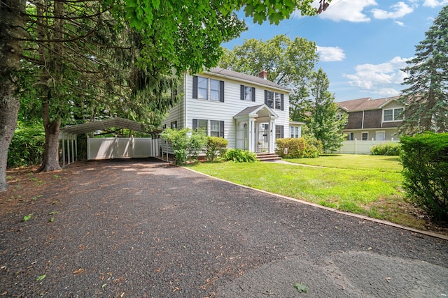 135 Park Ter, Waterbury, CT 06708 - colonial house with a carport, driveway, and a chimney