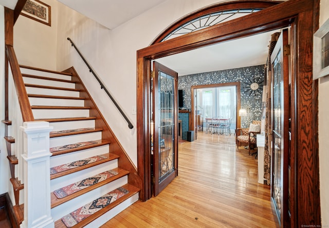 135 Park Ter, Waterbury, CT 06708 - foyer entrance featuring wallpapered walls, light wood-style flooring, stairs, and french doors