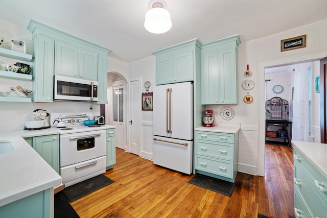 135 Park Ter, Waterbury, CT 06708 - kitchen with white appliances, arched walkways, light countertops, and open shelves