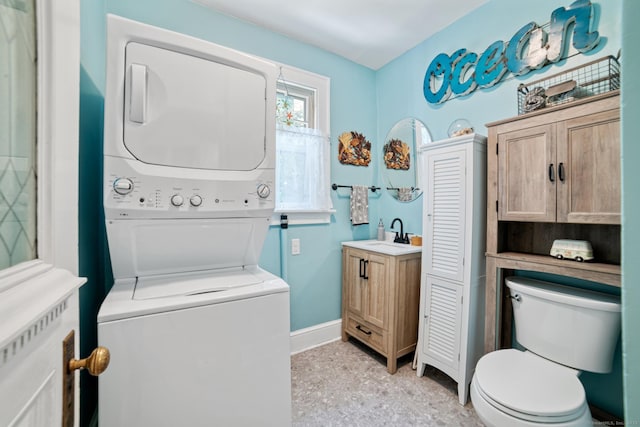 135 Park Ter, Waterbury, CT 06708 - bathroom featuring stacked washer and clothes dryer, vanity, and speckled floor