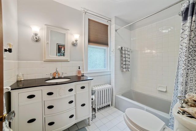 135 Park Ter, Waterbury, CT 06708 - bathroom with radiator heating unit, tile walls, tile patterned floors, vanity, and shower / bath combo