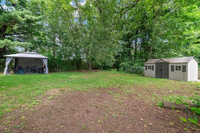 135 Park Ter, Waterbury, CT 06708 - view of grassy yard featuring a storage unit, a gazebo, and view of wooded area