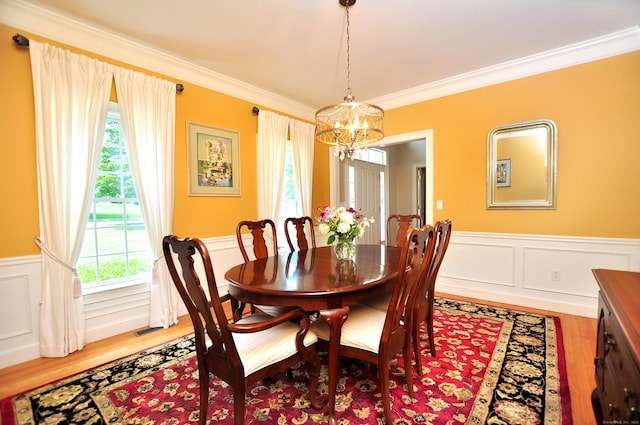 190 Shadow Pond, Suffield, CT 06078 - dining room featuring a chandelier, light wood-type flooring, a wainscoted wall, crown molding, and a decorative wall