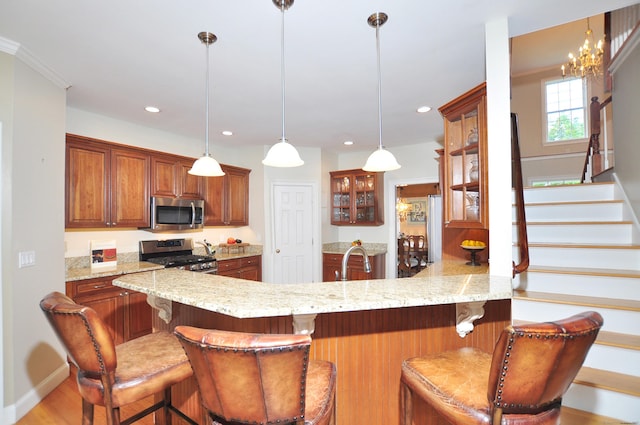 190 Shadow Pond, Suffield, CT 06078 - kitchen with appliances with stainless steel finishes, a peninsula, glass insert cabinets, light stone counters, and recessed lighting