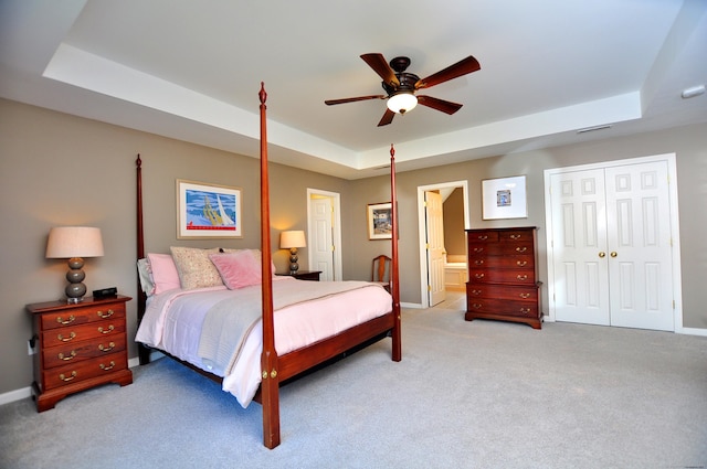190 Shadow Pond, Suffield, CT 06078 - bedroom featuring a tray ceiling, light carpet, and a closet
