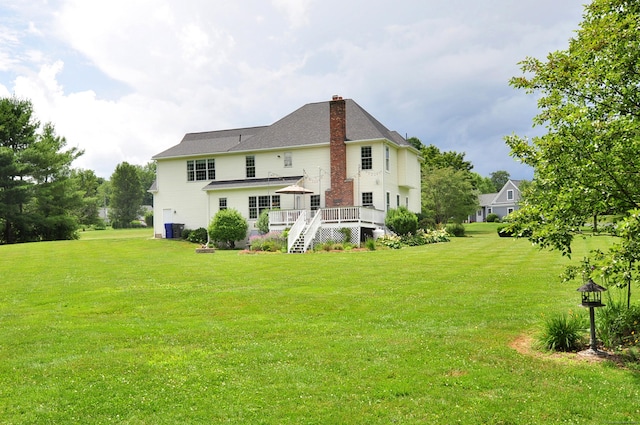 190 Shadow Pond, Suffield, CT 06078 - back of property with a chimney, a deck, a yard, and stairway