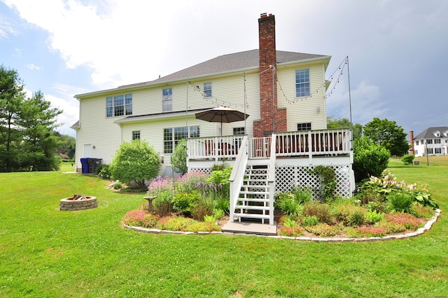190 Shadow Pond, Suffield, CT 06078 - back of property featuring a fire pit, stairway, a wooden deck, a lawn, and a chimney