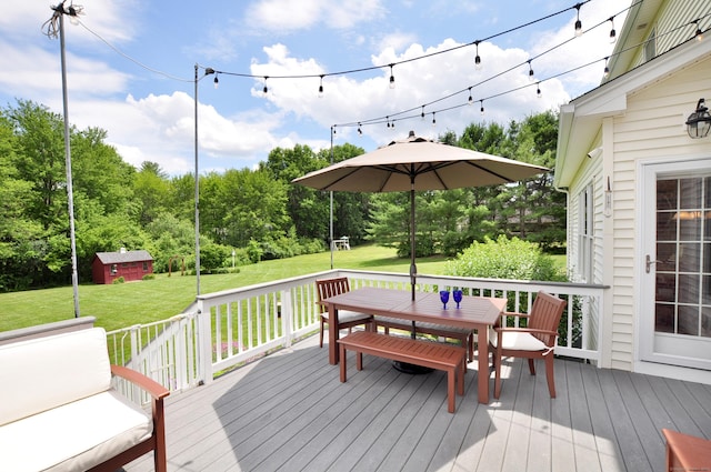 190 Shadow Pond, Suffield, CT 06078 - wooden deck with outdoor dining area, a lawn, an outbuilding, and view of scattered trees