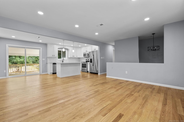 302 Fieldwood Rd, Waterbury, CT 06704 - unfurnished living room featuring recessed lighting, light wood-type flooring, and a chandelier
