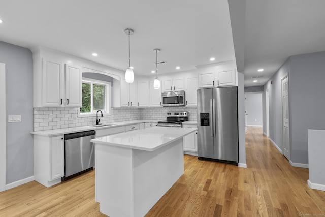 302 Fieldwood Rd, Waterbury, CT 06704 - kitchen featuring appliances with stainless steel finishes, backsplash, white cabinetry, light wood-style floors, and recessed lighting