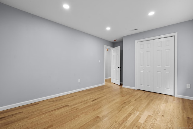 302 Fieldwood Rd, Waterbury, CT 06704 - unfurnished bedroom featuring light wood finished floors, recessed lighting, and a closet