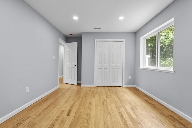 302 Fieldwood Rd, Waterbury, CT 06704 - unfurnished bedroom featuring multiple windows, light wood-style flooring, a closet, and recessed lighting