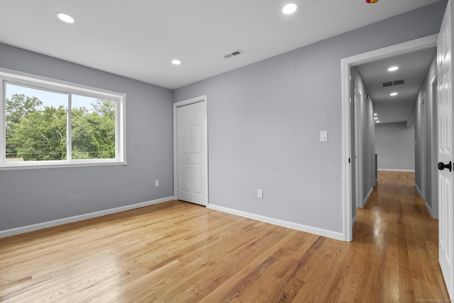 302 Fieldwood Rd, Waterbury, CT 06704 - unfurnished bedroom featuring light wood finished floors, recessed lighting, and a closet