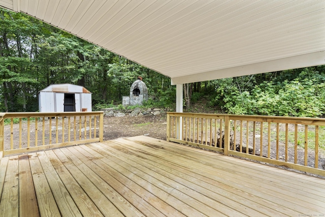 302 Fieldwood Rd, Waterbury, CT 06704 - wooden deck featuring a storage unit and view of scattered trees