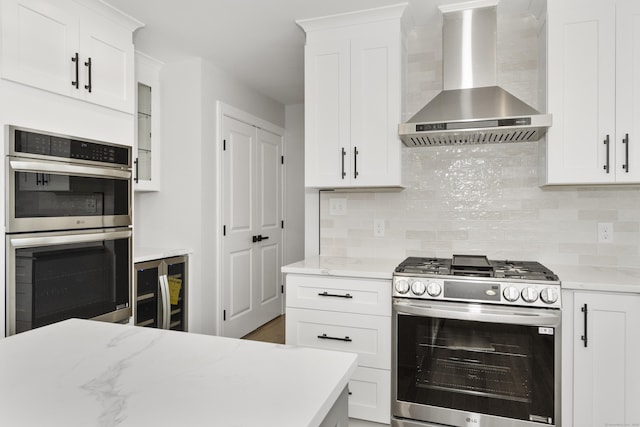 61 N Woods Rd, Hamden, CT 06518 - kitchen with wall chimney range hood, stainless steel appliances, wine cooler, and tasteful backsplash