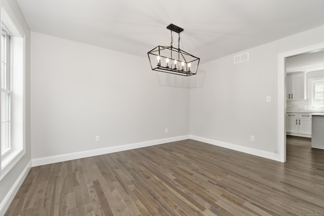 61 N Woods Rd, Hamden, CT 06518 - unfurnished dining area featuring a chandelier and dark wood-style floors