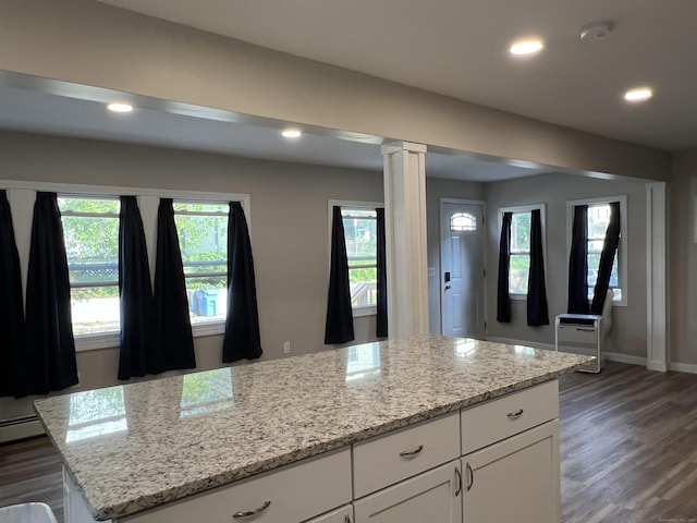 34 Division St, Norwich, CT 06360 - kitchen featuring recessed lighting, white cabinets, plenty of natural light, dark wood-type flooring, and ornate columns