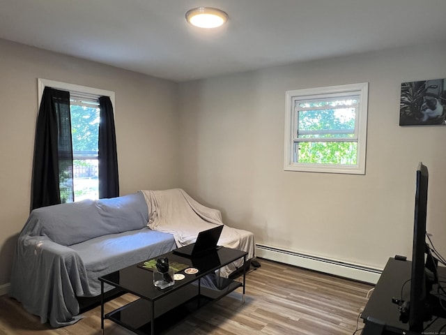 34 Division St, Norwich, CT 06360 - living area with baseboard heating and light wood finished floors