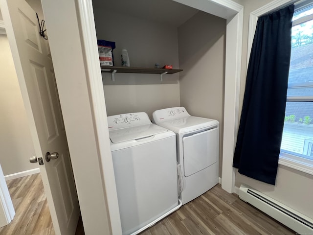 34 Division St, Norwich, CT 06360 - washroom featuring a baseboard heating unit, separate washer and dryer, and light wood-style flooring
