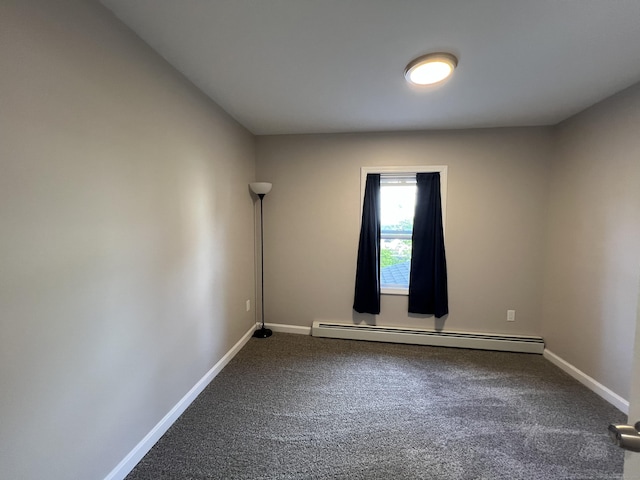 34 Division St, Norwich, CT 06360 - empty room featuring a baseboard heating unit and dark colored carpet