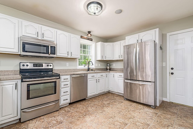 93 Cook Hill Rd, Killingly, CT 06239 - kitchen with appliances with stainless steel finishes, white cabinetry, and light countertops