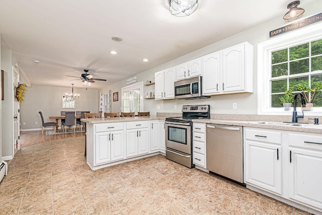 93 Cook Hill Rd, Killingly, CT 06239 - kitchen with appliances with stainless steel finishes, a peninsula, light countertops, white cabinetry, and recessed lighting