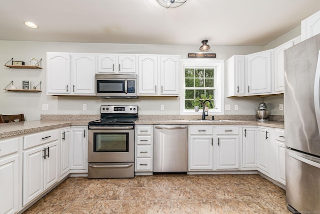 93 Cook Hill Rd, Killingly, CT 06239 - kitchen with appliances with stainless steel finishes, open shelves, white cabinetry, light countertops, and recessed lighting