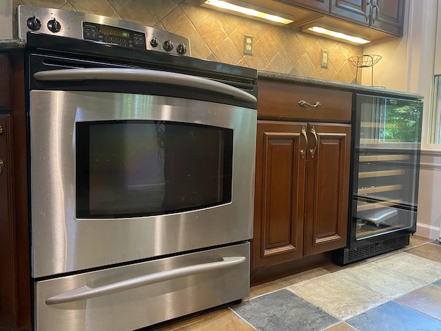 29 Grumman Ave, Wilton, CT 06897 - kitchen with beverage cooler, stainless steel electric stove, backsplash, and light stone finish flooring
