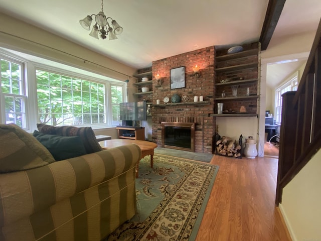 29 Grumman Ave, Wilton, CT 06897 - living area with wood finished floors, a fireplace, and a chandelier
