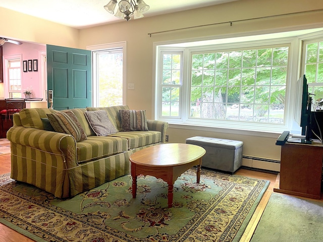 29 Grumman Ave, Wilton, CT 06897 - living area with a baseboard heating unit, wood finished floors, and a ceiling fan