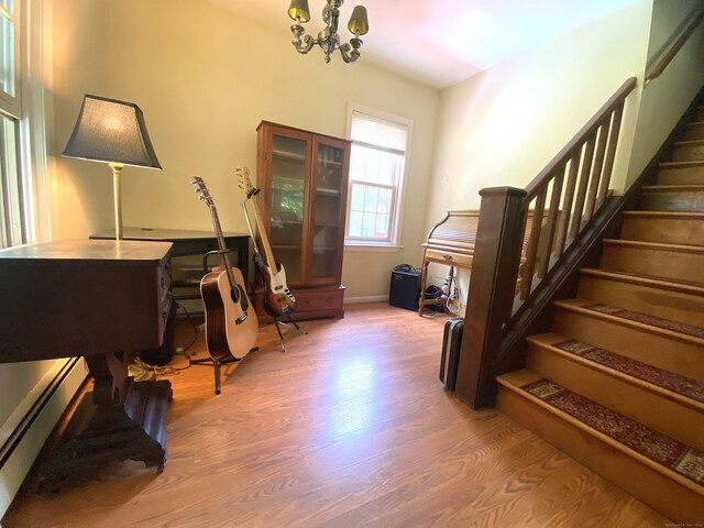 29 Grumman Ave, Wilton, CT 06897 - entrance foyer featuring wood finished floors, a chandelier, stairway, and baseboard heating